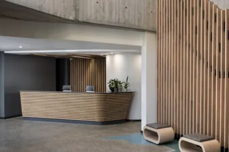 Slatted timber reception desk and screen, manufactured and installed by Nova Bespoke